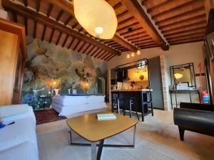 a living room with a white couch and a table at Gli sterpi in Sinalunga