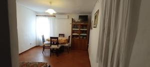 a dining room with a table and chairs and a window at Casa Bainsizza in Isnello