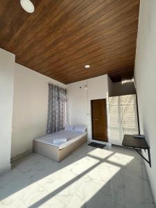 a bedroom with a bed and a wooden ceiling at Aizawl View Hotel in Āīzawl