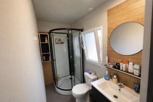 a bathroom with a shower and a toilet and a sink at Sea Mobile Home in Sukošan
