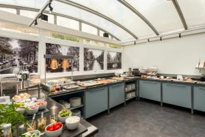 a large kitchen with a lot of food at City Hotel Rembrandt Square - Just renovated in Amsterdam
