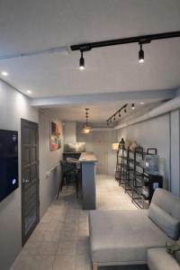 a living room and kitchen with a couch and a table at Hostel Samui in Nathon Bay