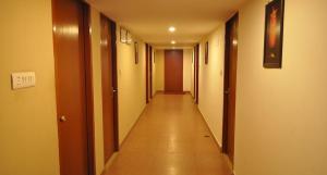 a long hallway with a long floor and some doors at Hotel Fort in Patna +3 photos