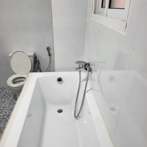 a white bath tub in a bathroom with a toilet at Résidence NOHA in Abidjan +20 photos
