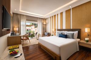 a hotel room with a large bed and a table at Taj Alibaug Resort & Spa, Maharashtra in Alibaug +43 photos