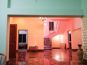 a hallway with a staircase in a house at Swapno Chhobi in Bolpur