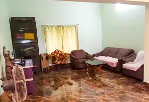 a living room with a couch and a table at Swapno Chhobi in Bolpur