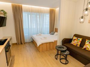 a small room with a bed and a couch at ToRo Hospitality in Mostar