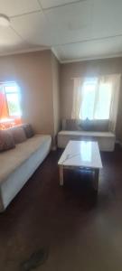 a room with two beds and a coffee table at Locsona flat in Margate