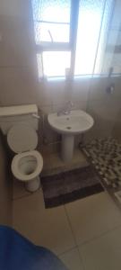 a bathroom with a toilet and a sink at Locsona flat in Margate