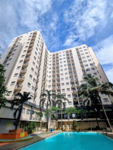 a large apartment building with a pool in front of it at Sahid Mutiara Karawaci in Tangerang