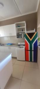 a kitchen with a colorful box sitting on the floor at Locsona flat in Margate
