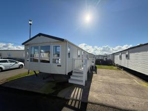 a tiny house is parked in a parking lot at Sleeps 8 guests lovely 3 Bedroom Golden Gate Towyn in Llanddulas