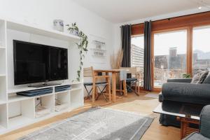 a living room with a large flat screen tv at Stilvoll und ruhig in Füssen