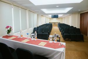 a conference room with chairs and a table with wine glasses at Sahid Mutiara Karawaci in Tangerang