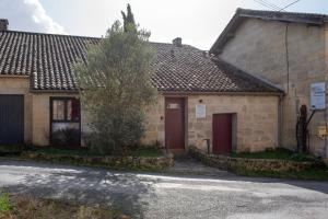 an old stone house with a red door at Château Croix Beauséjour "Maison du Vigneron" in Montagne