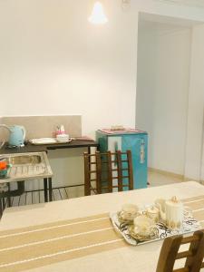 a table with a tray of cups and dishes on it at Jayalath Homestay and Apartments in Galle