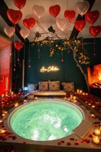 a room with a pool with hearts hanging from the ceiling at AMA Esclusive SPA Ariosto in Ferrara +30 photos