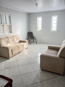 a living room with two couches and a table at Casa Laguna in Laguna