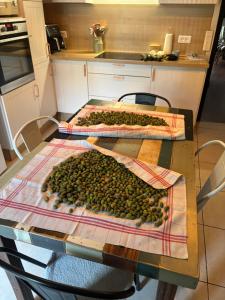 a table with two tables covered with olives on it at La Pause Bonheur La Campagnarde in Luc-sur-Orbieu