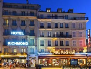 a large building with shops in front of it at Hotel Richmond Gare du Nord in Paris