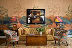 a living room with a couch and a mirror at The Soho Hotel, Firmdale Hotels in London