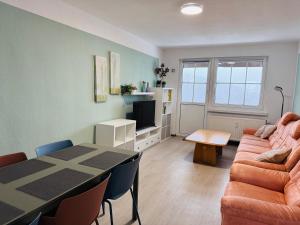 a living room with a table and a couch at FeWo Einetal 4 im schönen Ostharz in Schielo