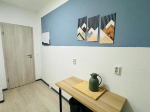 a room with a table with a vase on it at FeWo Einetal 4 im schönen Ostharz in Schielo +14 photos
