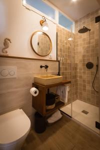 a bathroom with a toilet and a sink and a shower at The Wave House in Jávea