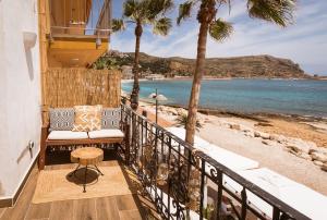 a balcony with a chair and a view of the beach at The Wave House in Jávea