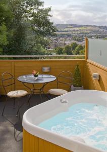 a pool with a table and chairs in it at Rocpool Reserve Hotel & Restaurant in Inverness