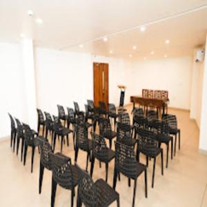 a room with a bunch of chairs and a table at IGNIVA Airport Hotel in Calicut