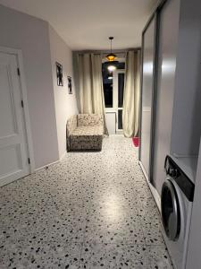 a laundry room with a chair and a washing machine at Апартаменти біля АС-1 Зацепи in Lutsk