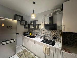 a kitchen with white cabinets and a refrigerator at Апартаменти біля АС-1 Зацепи in Lutsk