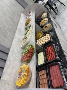 a table with many different types of food on it at ReveL HoteL in Tashkent