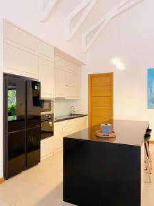 a kitchen with a black refrigerator and a counter top at SEACoastar in Xuyên Mộc