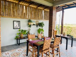 a patio with a table and chairs on a patio at Sanctuary Homestay Battambang in Phumĭ Don Téav