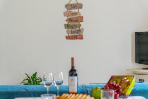 a bottle of wine sitting on a table with wine glasses at Gouveia Cottage in Seixal +44 photos