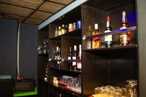 a bar with many bottles of alcohol on shelves at Mbre Hotel and Resorts in Uyo