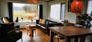 a living room with a couch and a table at Bed and Breakfast Op het Broek in Harfsen