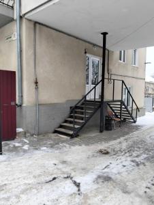 a staircase in a building with snow on the ground at Бордуляка 11 in Ternopil
