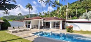 a villa with a swimming pool and a house at SAWAN Residence Pool Villas in Lamai