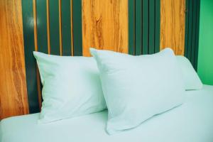 two white pillows sitting on top of a bed at Mbre Hotel and Resorts in Uyo