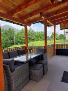 a patio with a table and chairs on a deck at Ferienhaus Skarbina in Zell-Pfarre