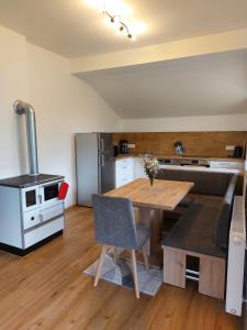 a kitchen with a wooden table and a stove at Ferienhaus Skarbina in Zell-Pfarre +14 photos