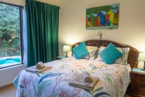 a bedroom with a bed with two towels and a window at The Shores, Ramsgate in Ramsgate +24 photos