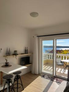 a kitchen with a large sliding glass door leading to a balcony at Villa Rosana in Rab