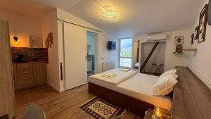 a small bedroom with a bed and a bathroom at Wood Nest in Bragadiru