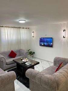 a living room with two couches and a table at W3 property in Kerak