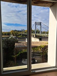 a view of a bridge from a window at Aux Rives Tranquilles, appartement bord de Loire avec vue in Les Rosiers